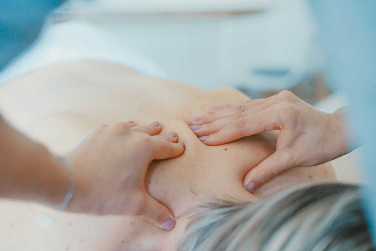 A therapist massaging a guest's shoulders
